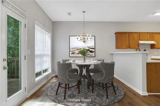 a view of a dining room with furniture window and wooden floor