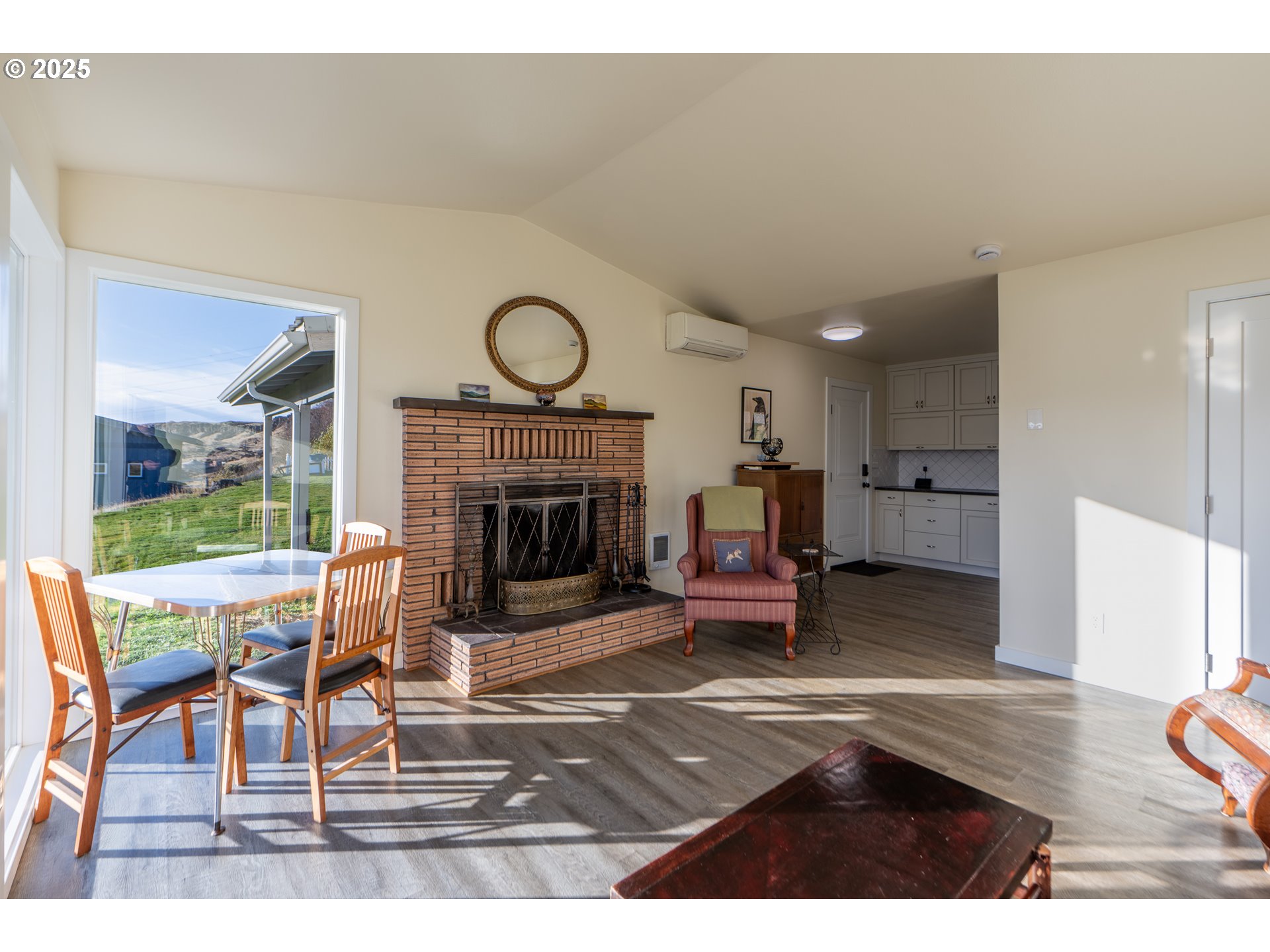 350 Bluff Road Wishram, WA 98673 - Photo 13 of 36 a living room with furniture a wooden floor and a fireplace