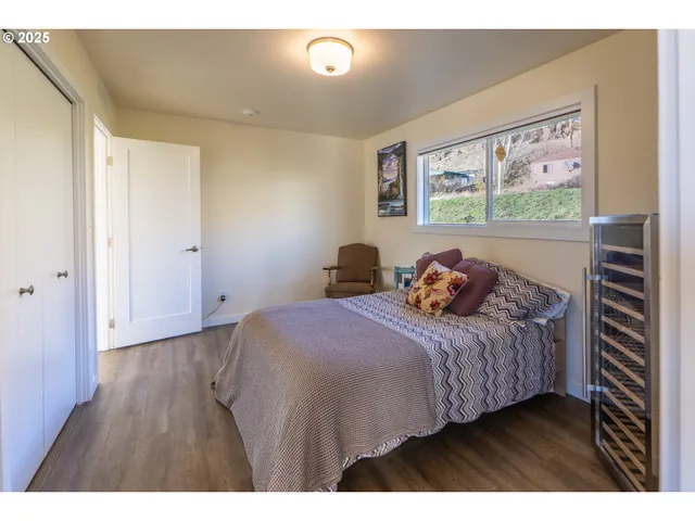 a bedroom with a bed and a painting on the wall