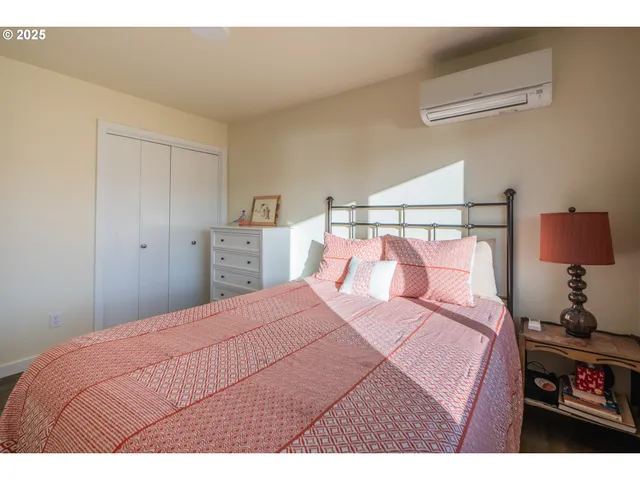 a bedroom with a bed and a night stand