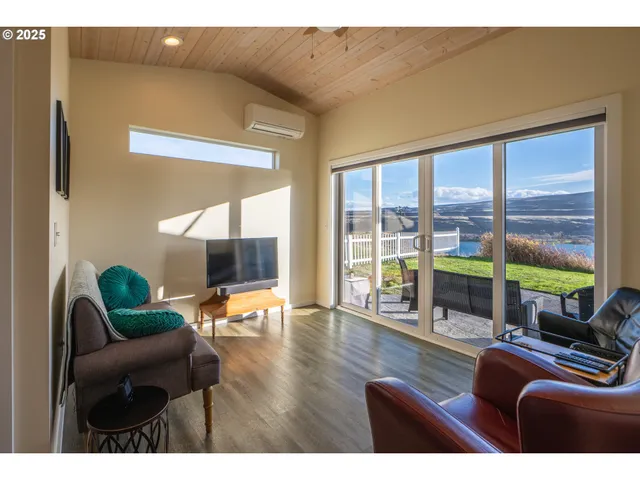 a living room with furniture and floor to ceiling window