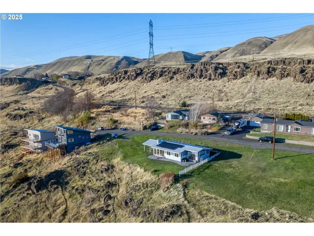 a aerial view of a house with a garden and mountain view