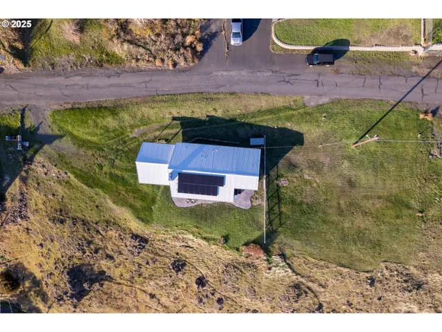 a aerial view of a house with a yard