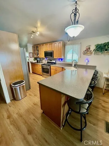 a dining room with wooden floor and breakfast area