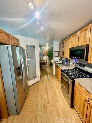 a kitchen with stainless steel appliances granite countertop a refrigerator stove and sink