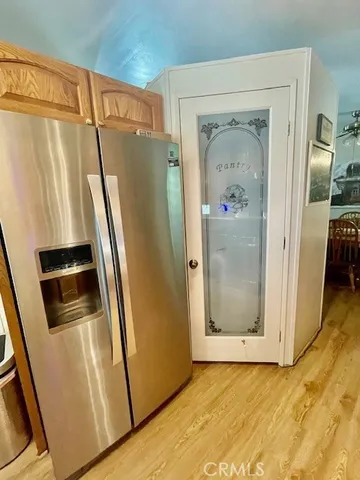 a view of a refrigerator in kitchen and wooden floor