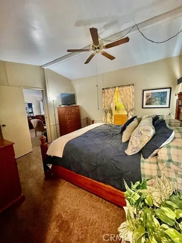 a bed room with a bed and a chandelier