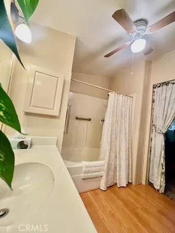 a bathroom with a tub sink and a mirror