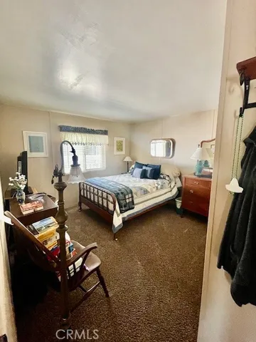 a bedroom with double bed and a couch