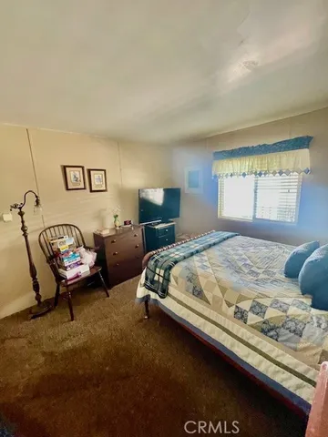 a bedroom with bed and window