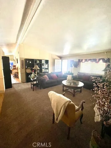 a living room with furniture a rug and a large window
