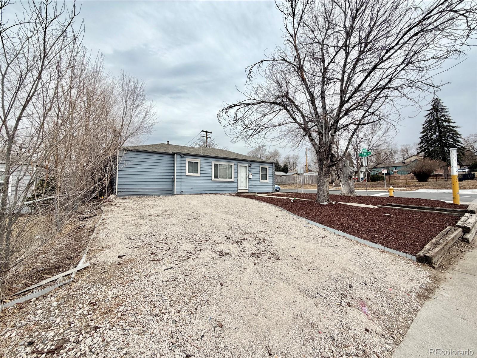 a pathway of a house with a yard covered in snow