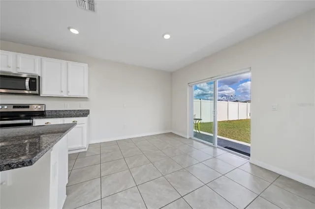 a view of a bedroom with furniture and windows
