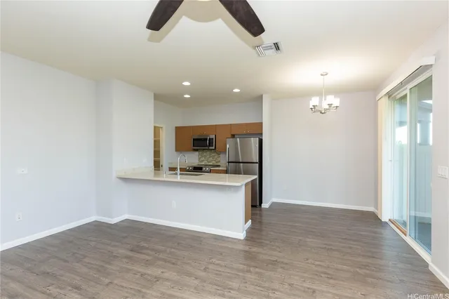 a view of kitchen with sink microwave and refrigerator