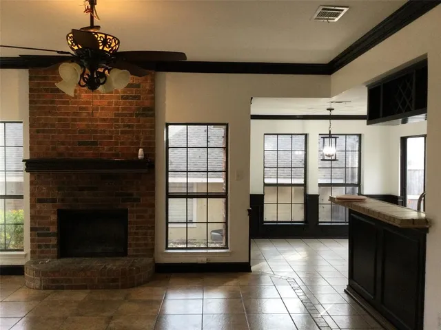 a view of a livingroom with a fireplace and windows