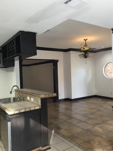 a view of a living room a chandelier and wooden floor