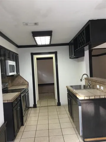 a kitchen with a sink and a stove top oven