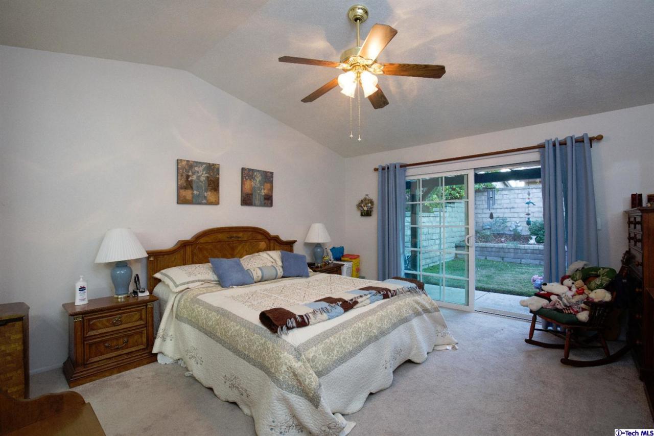25633 Salceda Road Valencia, CA 91355 - Photo 11 of 29 a bed room with a bed and a chandelier