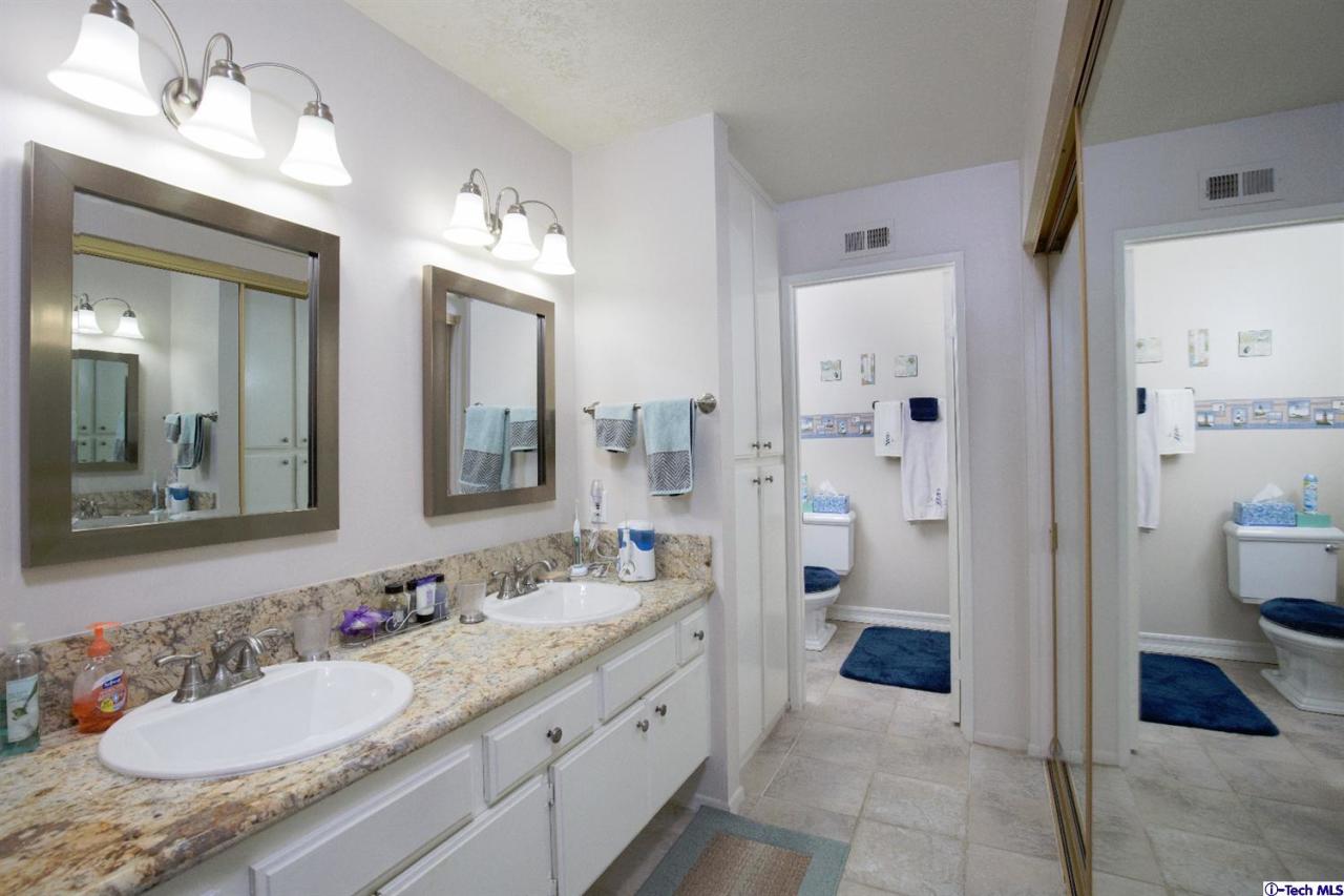 25633 Salceda Road Valencia, CA 91355 - Photo 13 of 29 a spacious bathroom with a granite countertop sink and a mirror