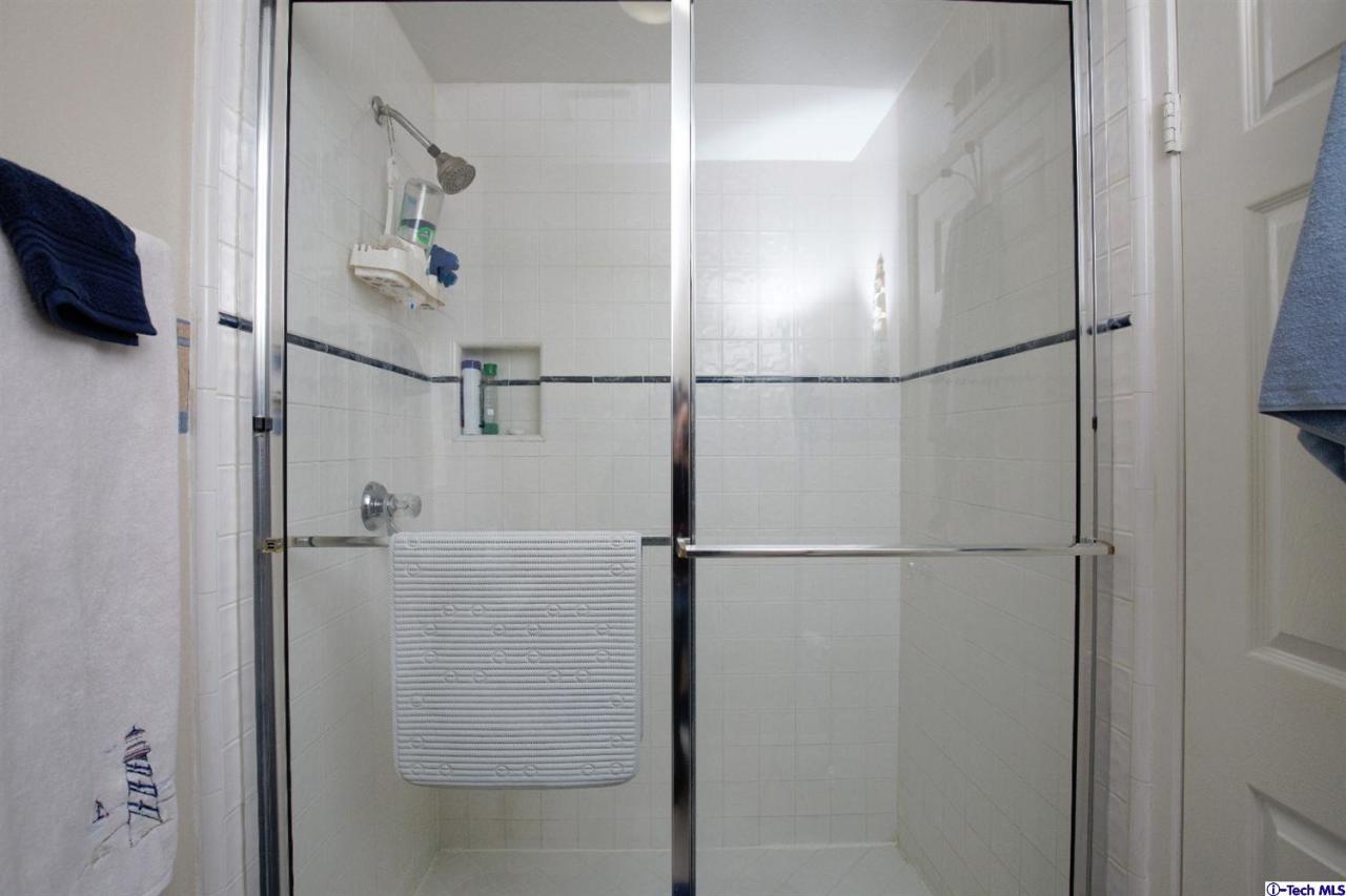 25633 Salceda Road Valencia, CA 91355 - Photo 14 of 29 a bathroom with a glass shower door