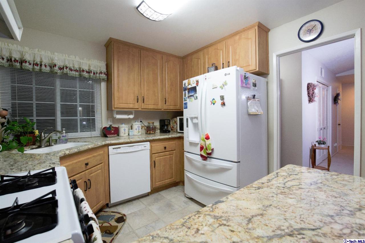 25633 Salceda Road Valencia, CA 91355 - Photo 28 of 29 a kitchen with stainless steel appliances granite countertop a refrigerator and a stove top oven
