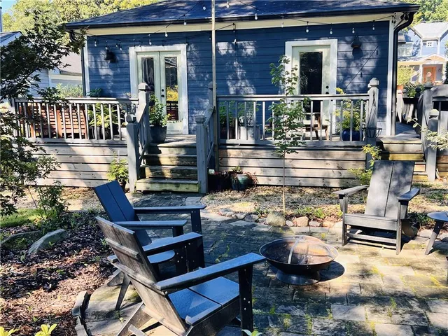 a front view of a house with outdoor seating