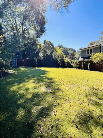 a view of back yard with swimming pool