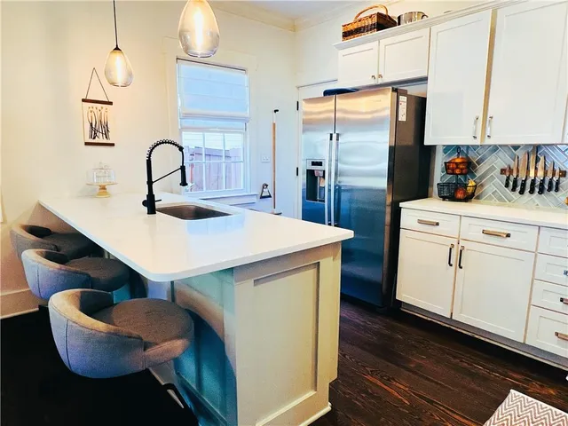 a kitchen with a sink cabinets and appliances