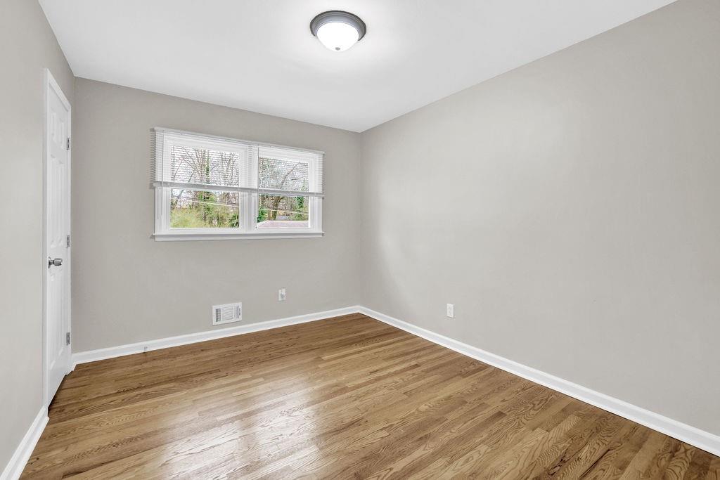 3091 Clifton Road Southeast Smyrna, GA 30080 - Photo 18 of 36 an empty room with wooden floor and windows