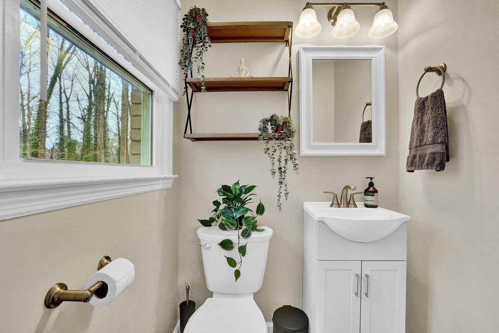 3091 Clifton Road Southeast Smyrna, GA 30080 - Photo 27 of 36 a bathroom with a sink mirror and toilet