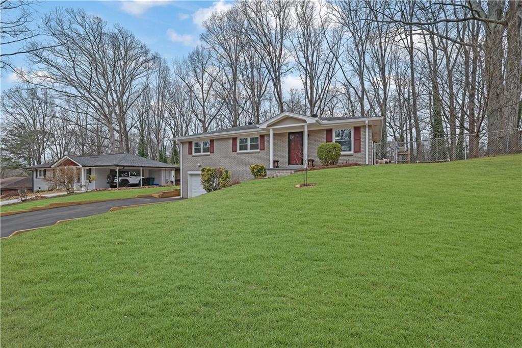 3091 Clifton Road Southeast Smyrna, GA 30080 - Photo 3 of 36 a front view of a house with garden