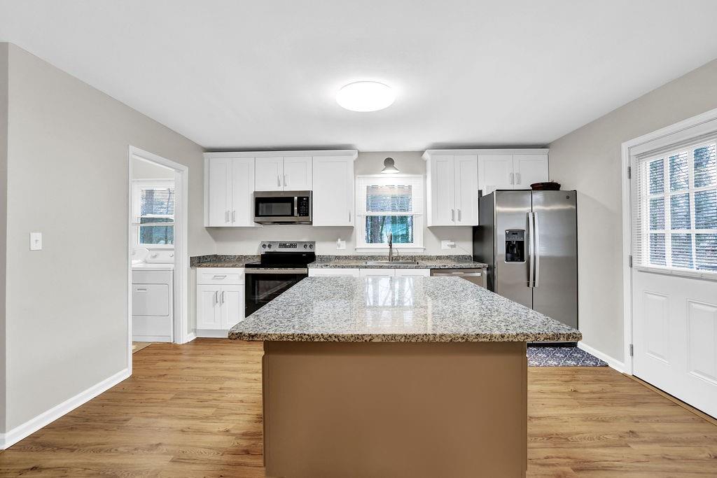 3091 Clifton Road Southeast Smyrna, GA 30080 - Photo 9 of 36 a kitchen with granite countertop a refrigerator and a stove top oven