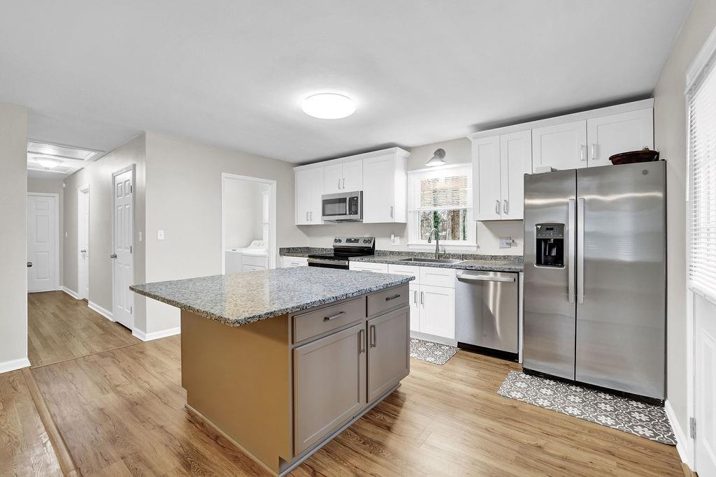 3091 Clifton Road Southeast Smyrna, GA 30080 - Photo 10 of 36 a kitchen with stainless steel appliances granite countertop a refrigerator a stove and a sink
