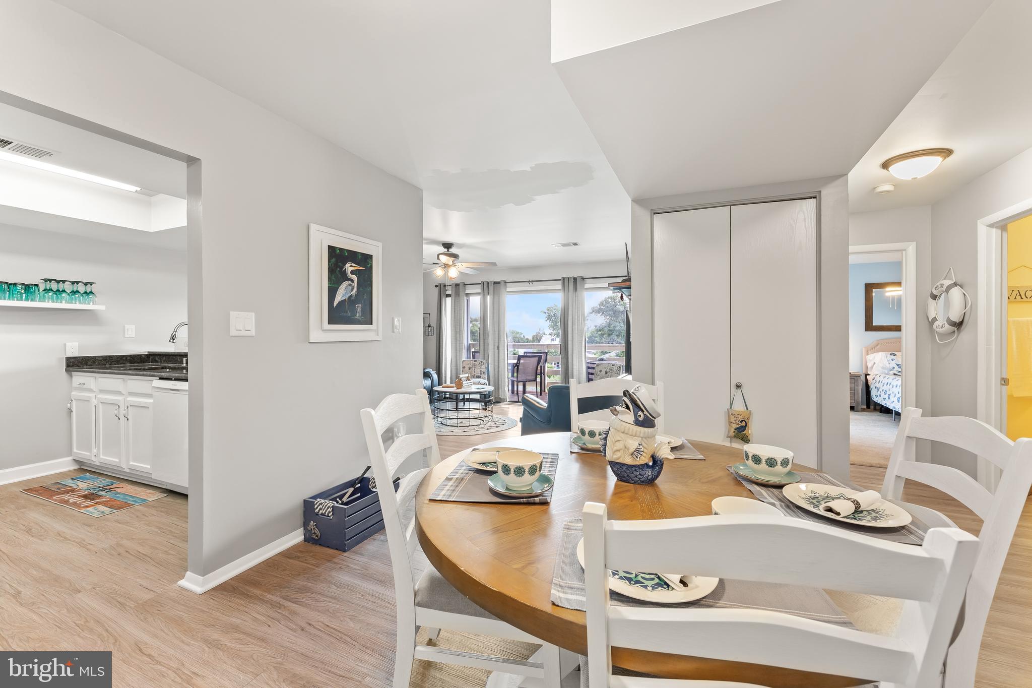 715 Washington Colonial Beach, Unit 15 Colonial Beach, VA 22443 - Photo 12 of 42 a view of a dining room with furniture a kitchen and chandelier