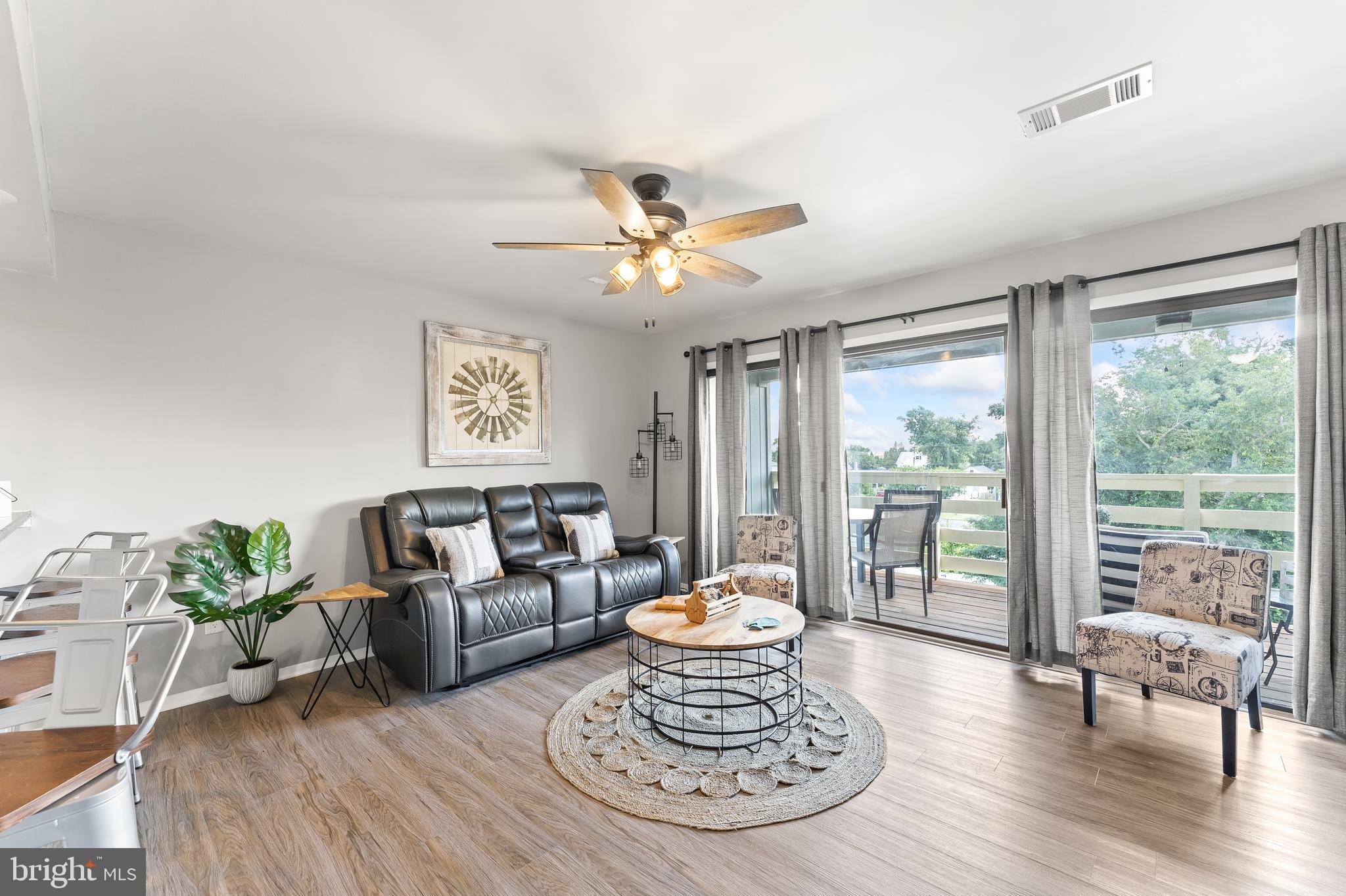 715 Washington Colonial Beach, Unit 15 Colonial Beach, VA 22443 - Photo 14 of 42 a living room with furniture and a large window with garden view