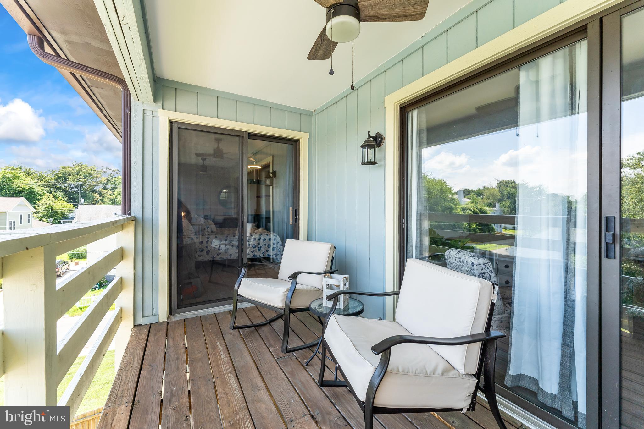 715 Washington Colonial Beach, Unit 15 Colonial Beach, VA 22443 - Photo 18 of 42 a balcony with wooden floor and outdoor seating