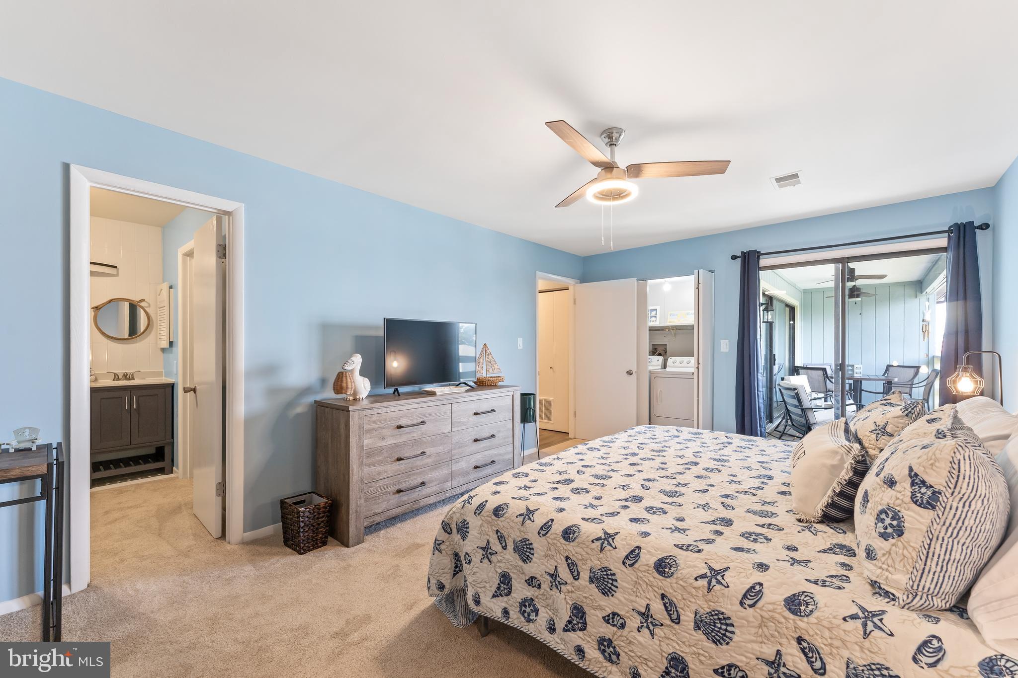 715 Washington Colonial Beach, Unit 15 Colonial Beach, VA 22443 - Photo 21 of 42 a bedroom with a large bed and a flat tv screen