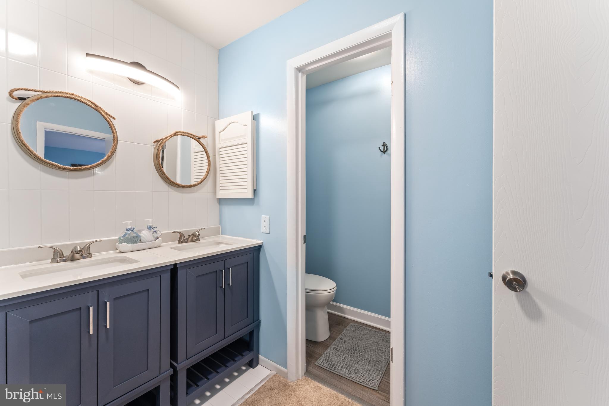 715 Washington Colonial Beach, Unit 15 Colonial Beach, VA 22443 - Photo 23 of 42 a bathroom with a toilet sink and mirror