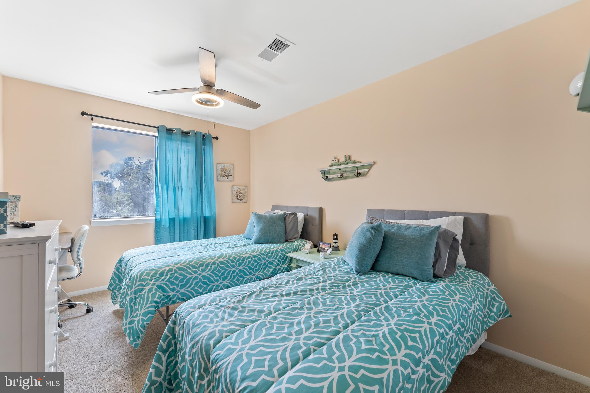 715 Washington Colonial Beach, Unit 15 Colonial Beach, VA 22443 - Photo 26 of 42 a bedroom with a bed and a chandelier