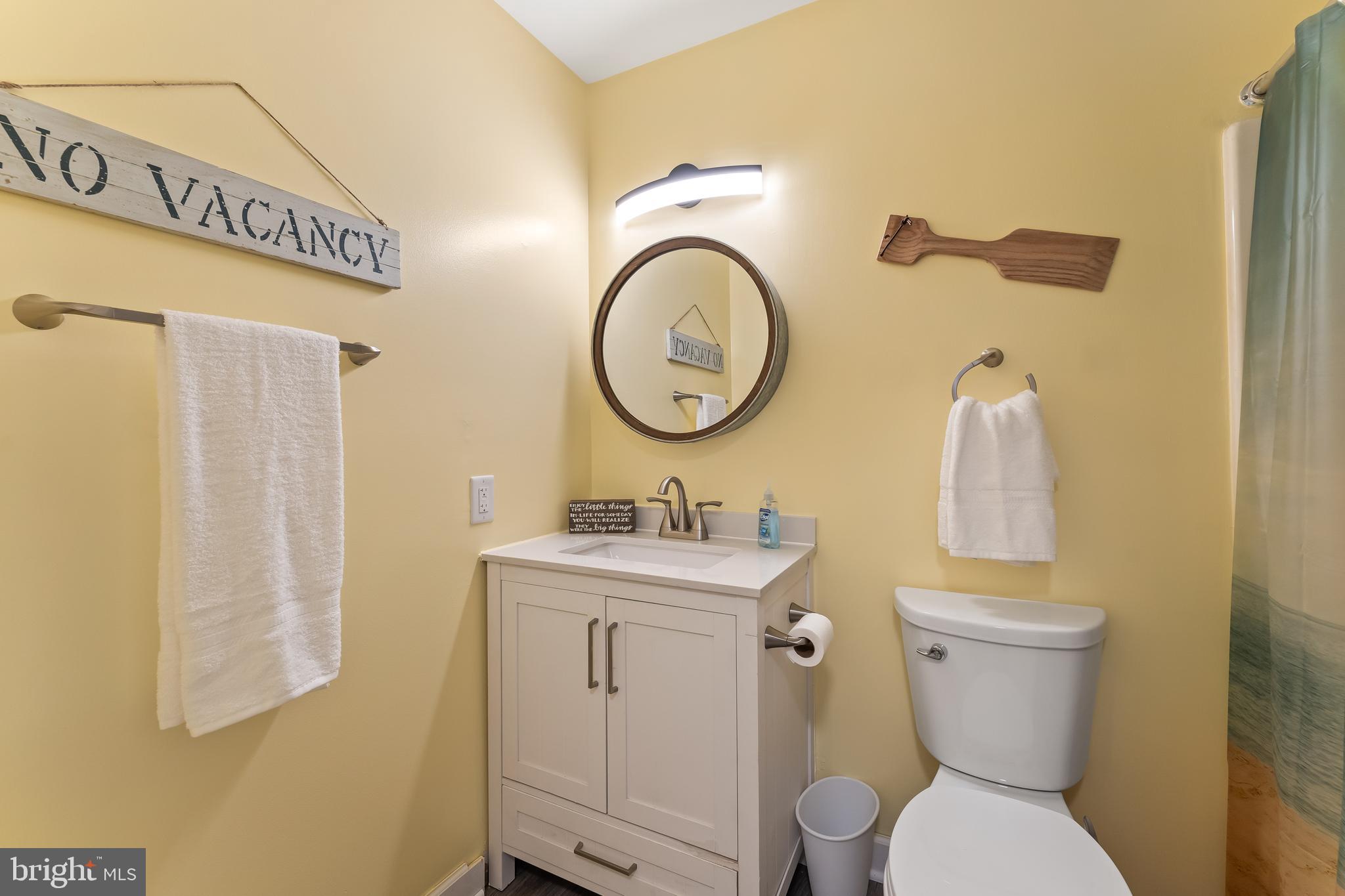 715 Washington Colonial Beach, Unit 15 Colonial Beach, VA 22443 - Photo 29 of 42 a bathroom with a toilet sink and mirror