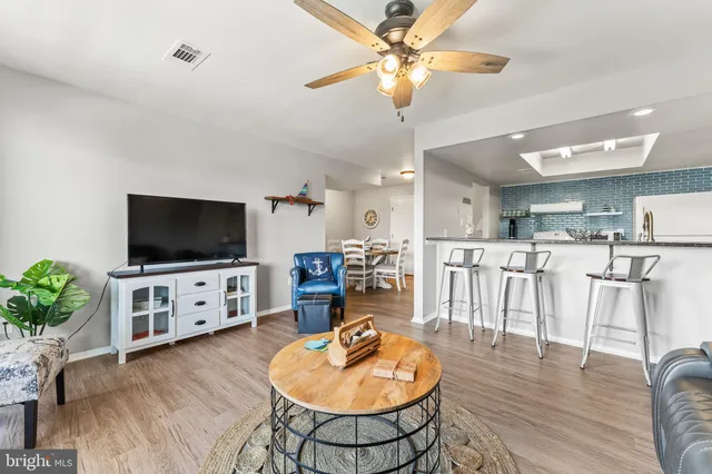 a kitchen with stainless steel appliances a table and chairs in it