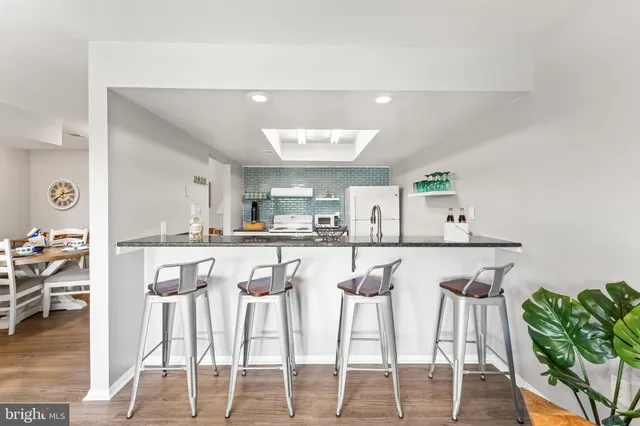 a kitchen with granite countertop a stove and a refrigerator