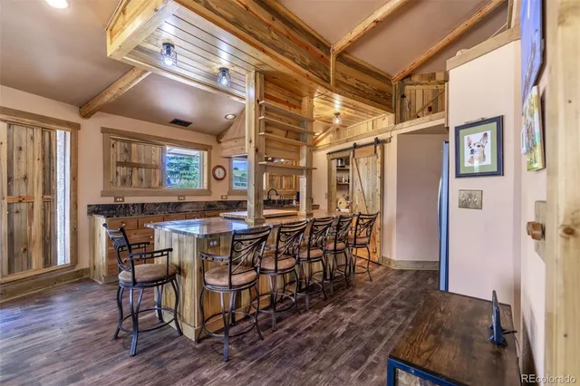a large kitchen with lots of counter space and wooden floor