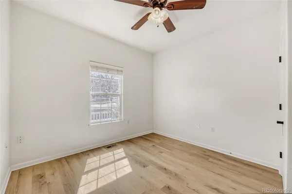 wooden floor in an empty room with a window