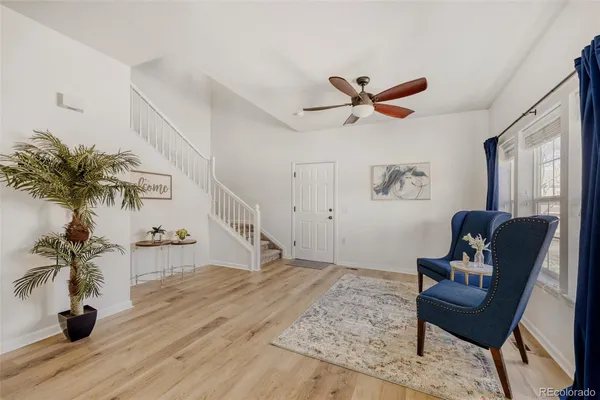 a living room with furniture and a potted plant