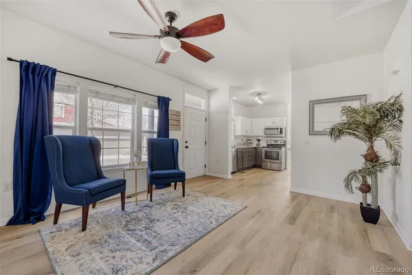 a living room with furniture and a wooden floor