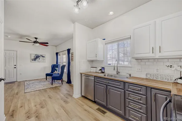 a kitchen with a sink window and cabinets