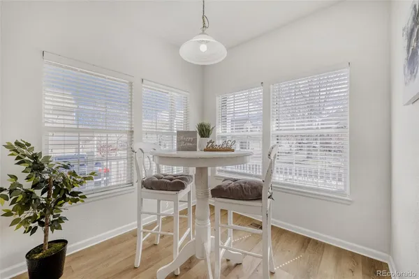 a dining room with furniture and wooden floor