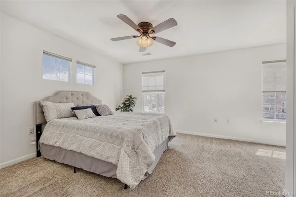 a spacious bedroom with a bed and window