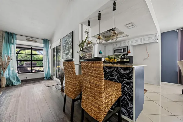 a dining room with furniture and wooden floor